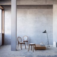 Two white Tranquebar chairs and a stool by Ca'lyah in a concrete room