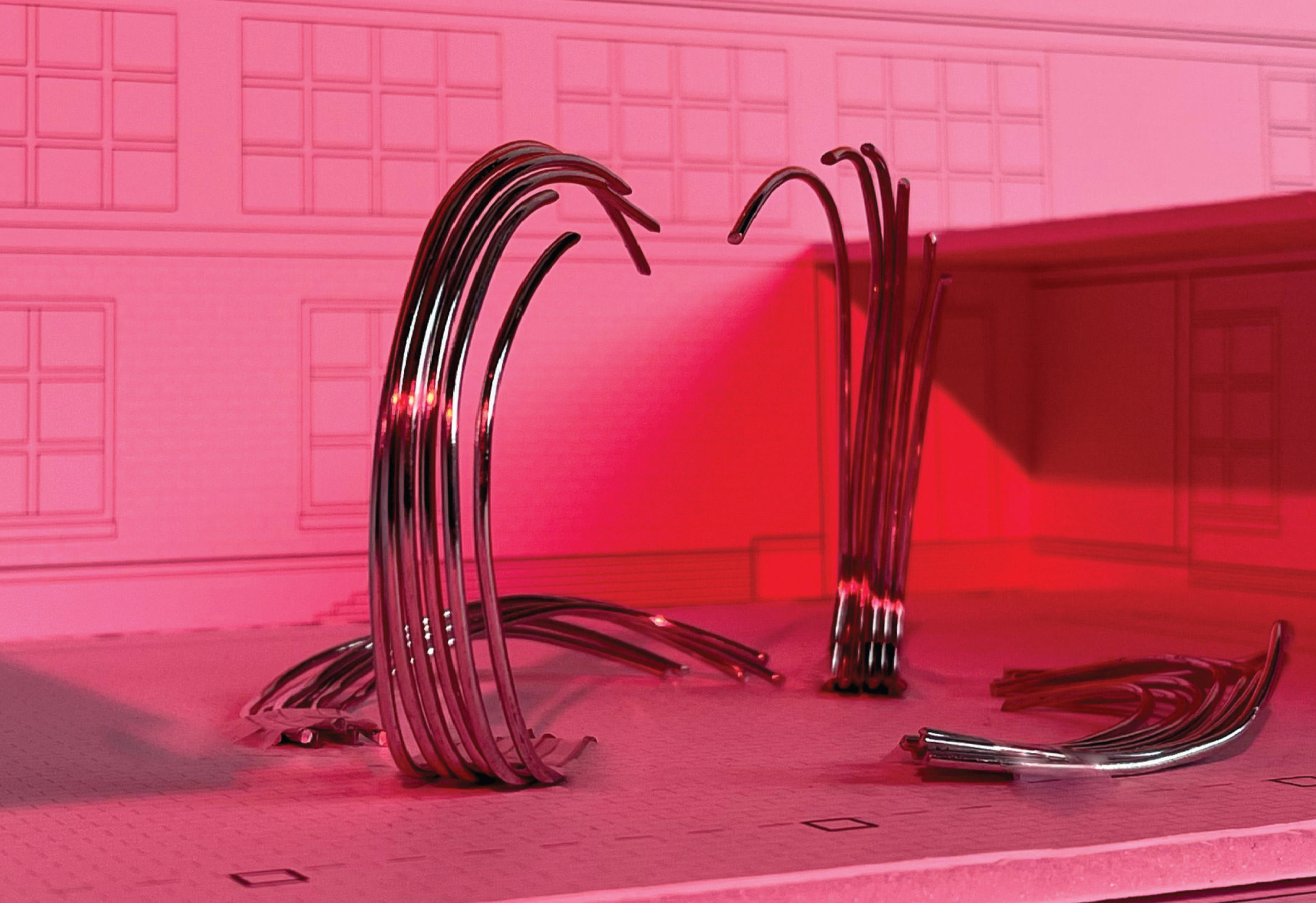 Photograph of pink model with arching metal structures
