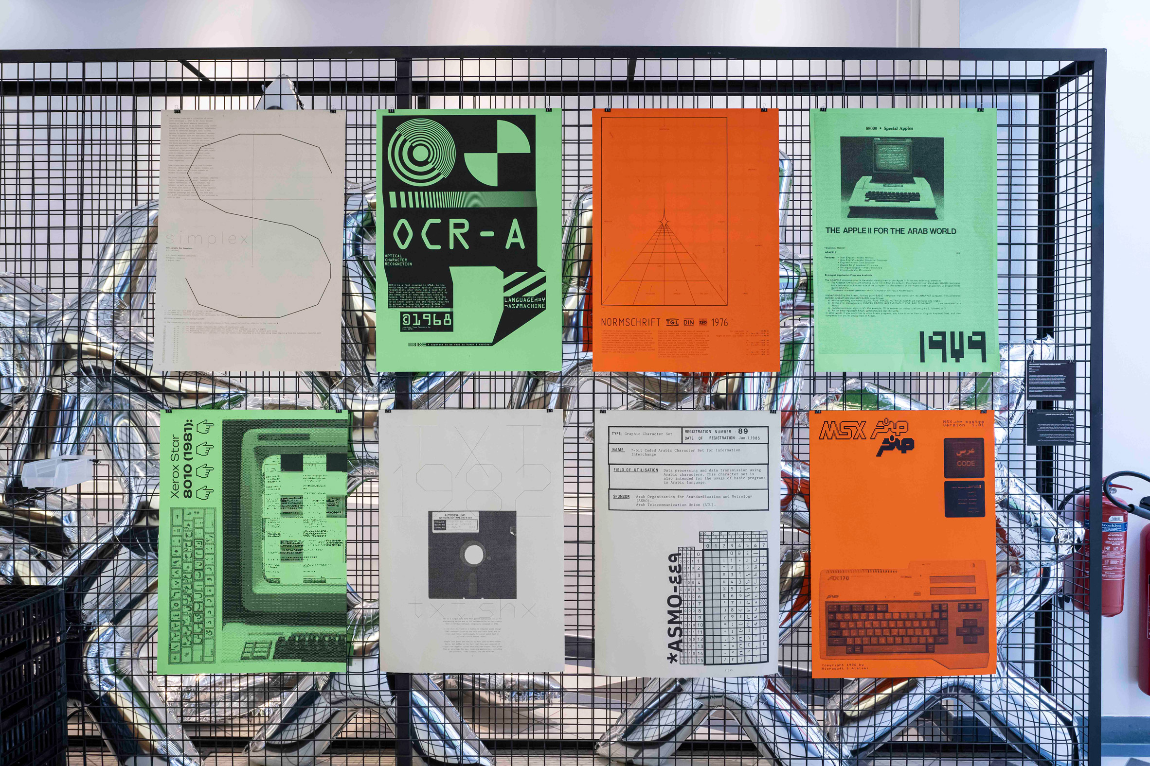 Photograph showing eight posters attached to a gridded screen