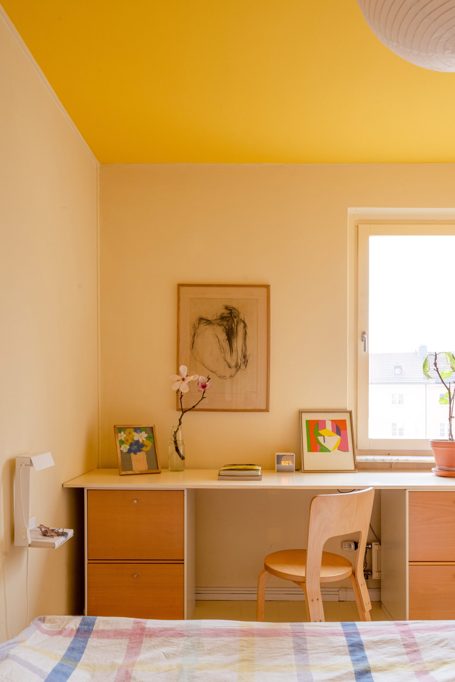 Yellow ceiling within parents' bedroom of Stockholm apartment