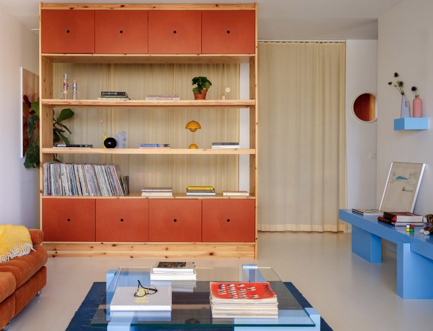 Burnt orange-hued geometric bookshelf within living space of Stockholm apartment by Westblom Krasse Arkitektkontor