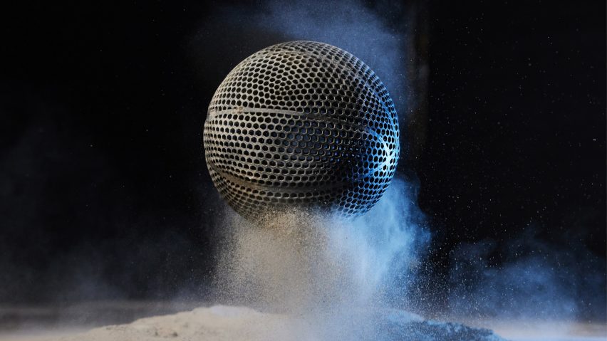 Black airless 3D-printed basketball by Wilson bouncing on a powder material