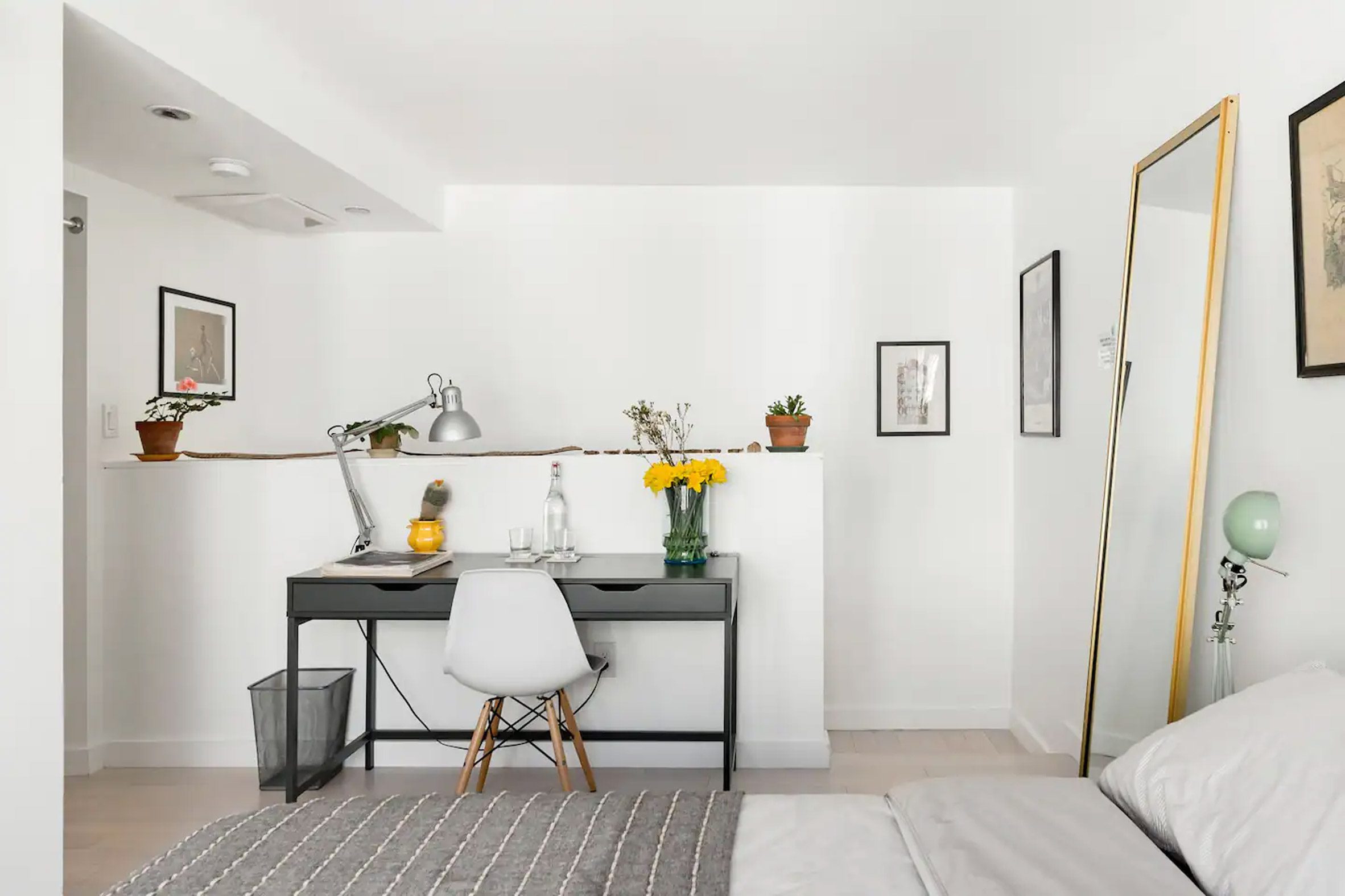 White interior featuring a desk and large mirror