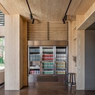Timber-clad room with polished concrete flor and fridges filled with beer