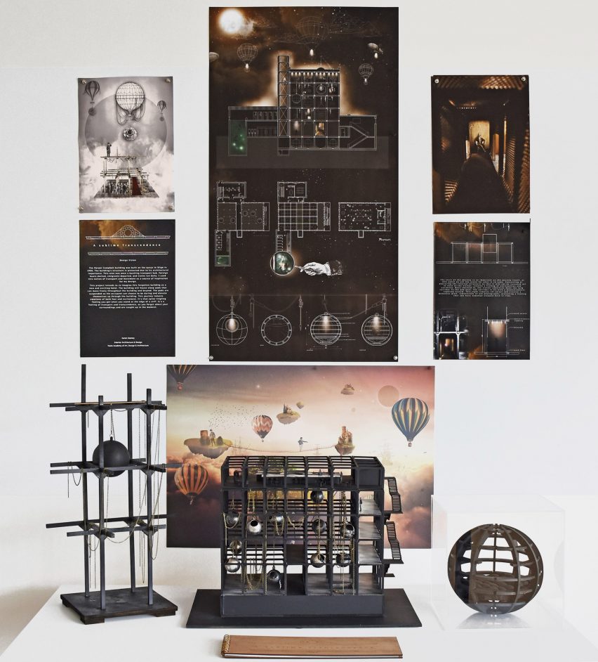 A photograph of a display that includes a model and print-outs with technical drawings