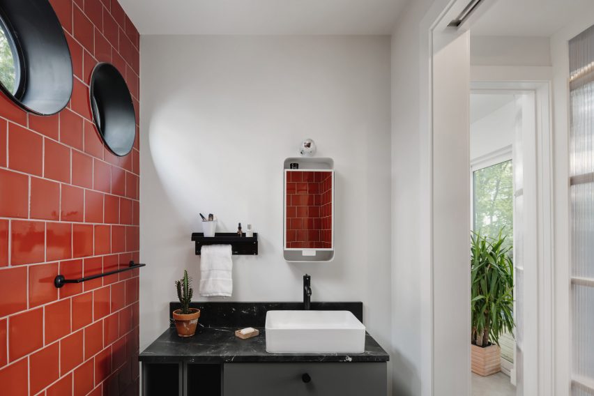 Bathroom with red tiles and small circular windows