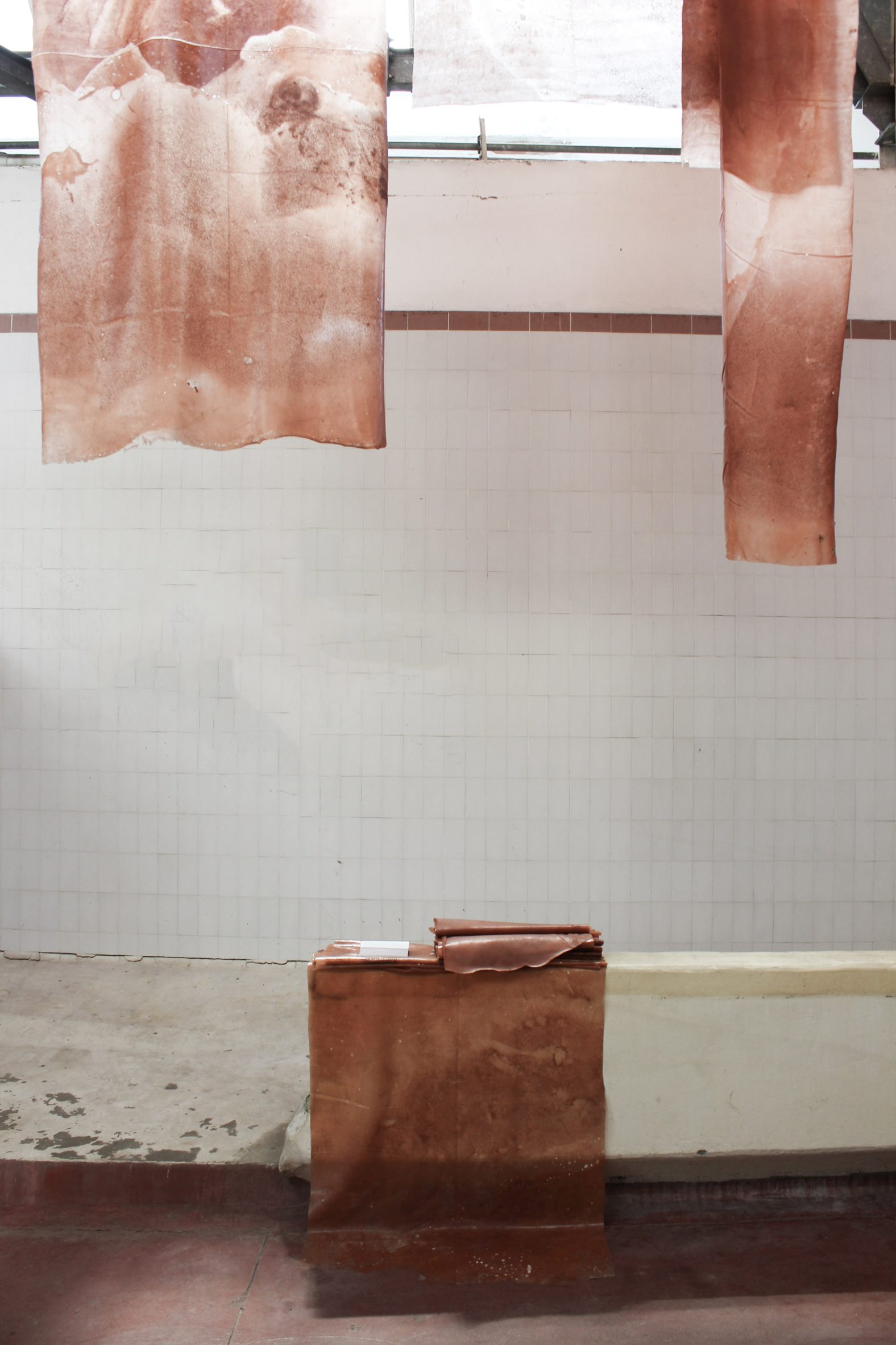 Hanging textiles that form a "biomaterial matrix" on display at Milan design week