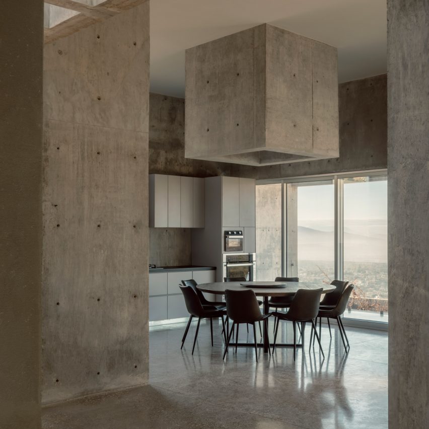 Kitchen within concrete house embedded into Oaxacan hillside by Espacio 18 Arquitectura