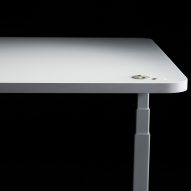 Light-coloured desk on black background