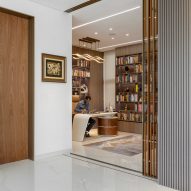 Interior space with white walls, glossy white floors, wooden door and a office desk