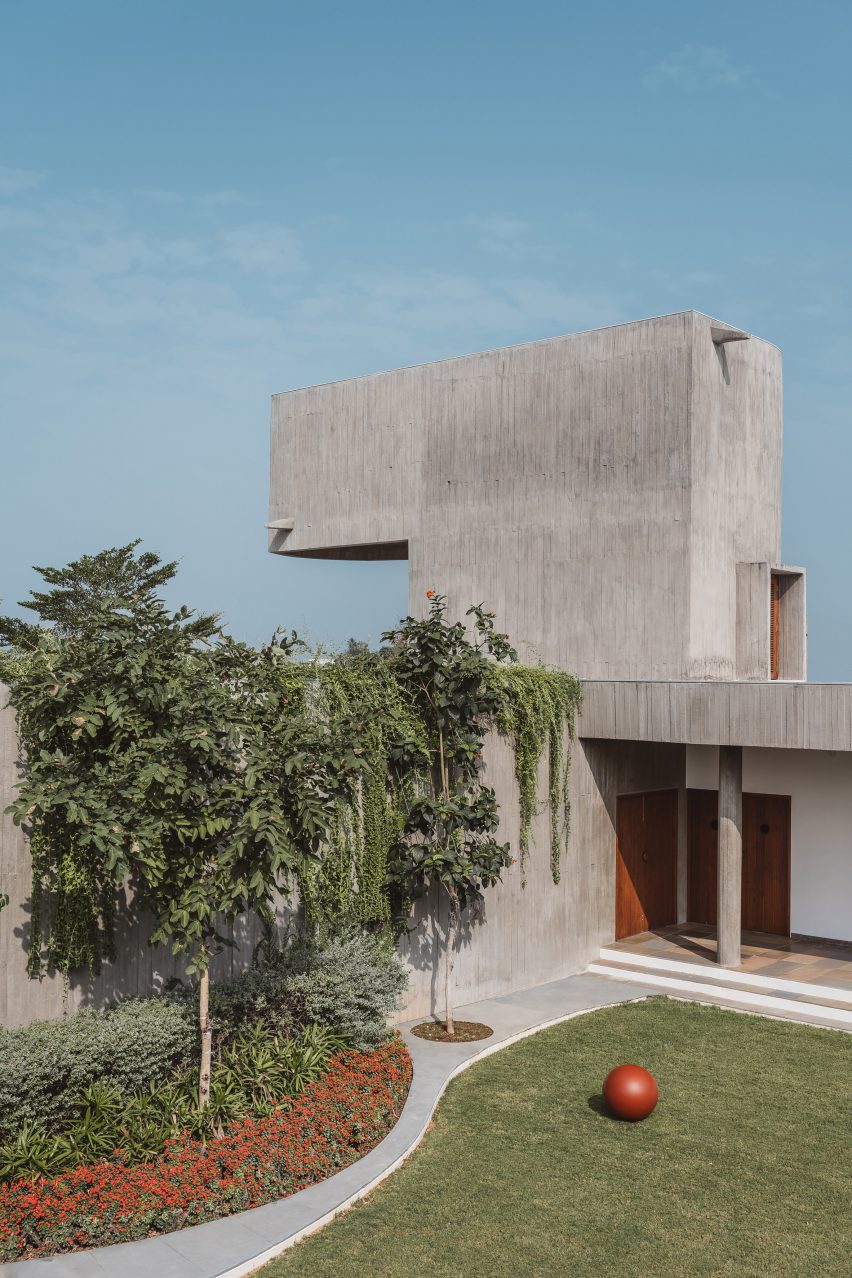 A grass lawn and trees surrounded by a concrete home