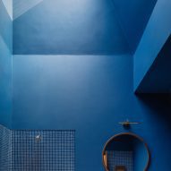 Monochrome blue bathroom with a skylight