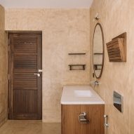 Bathroom with cream walls, brown-tiled floor and wooden vanity unit