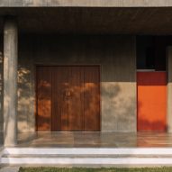 Outdoor porch with concrete walls and floors and wood double doors