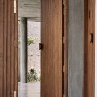 Wooden doorway in a room with polished concrete floors and concrete walls