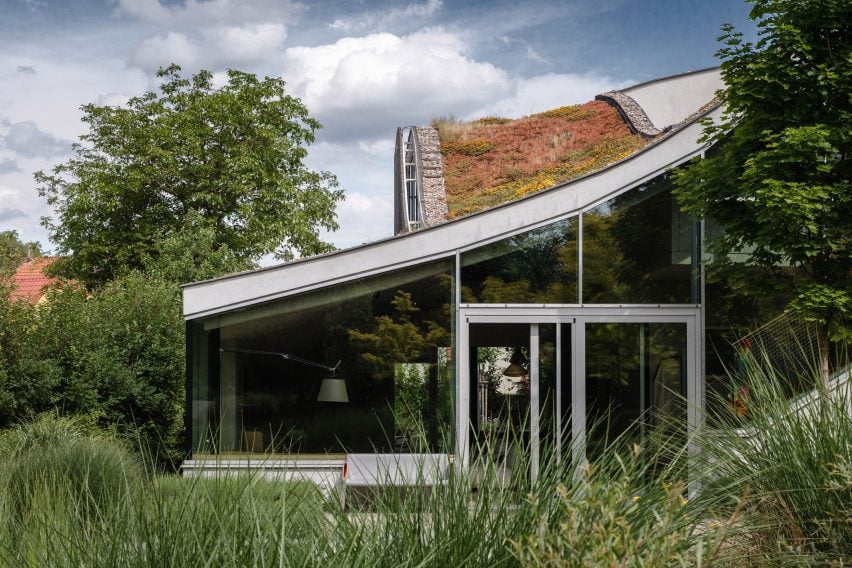 House with glass facade and green roof