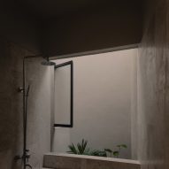 Concrete bathroom with sunken bathtub