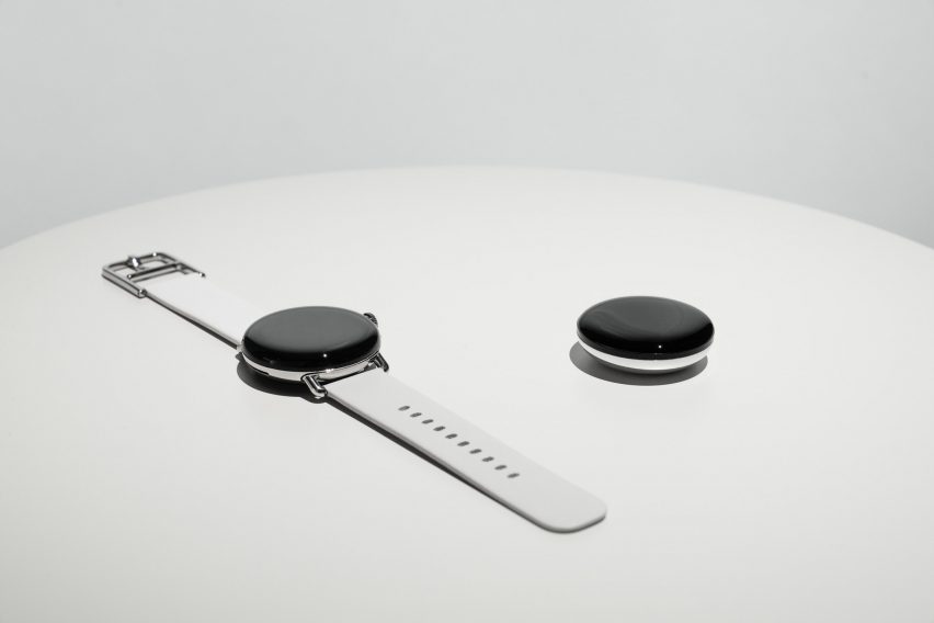 Close-up of Google Pixel watch next to disk with water puddle