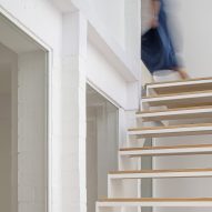 White interior with a a staircase with wood treads and gaps between them