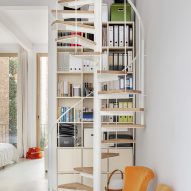 White interior with a spiral staircase with wooden treads