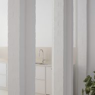 White kitchen with white cabinets and square columns