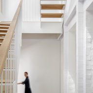White interior with a a staircase with wood treads and open space between them