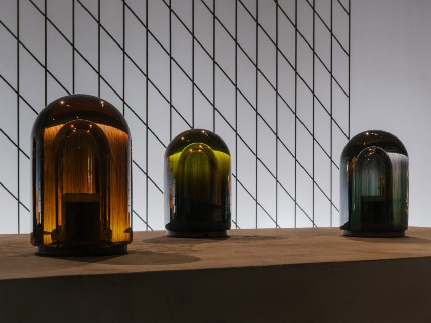 Lantern-style coloured lamps on concrete plinths by Hermès 