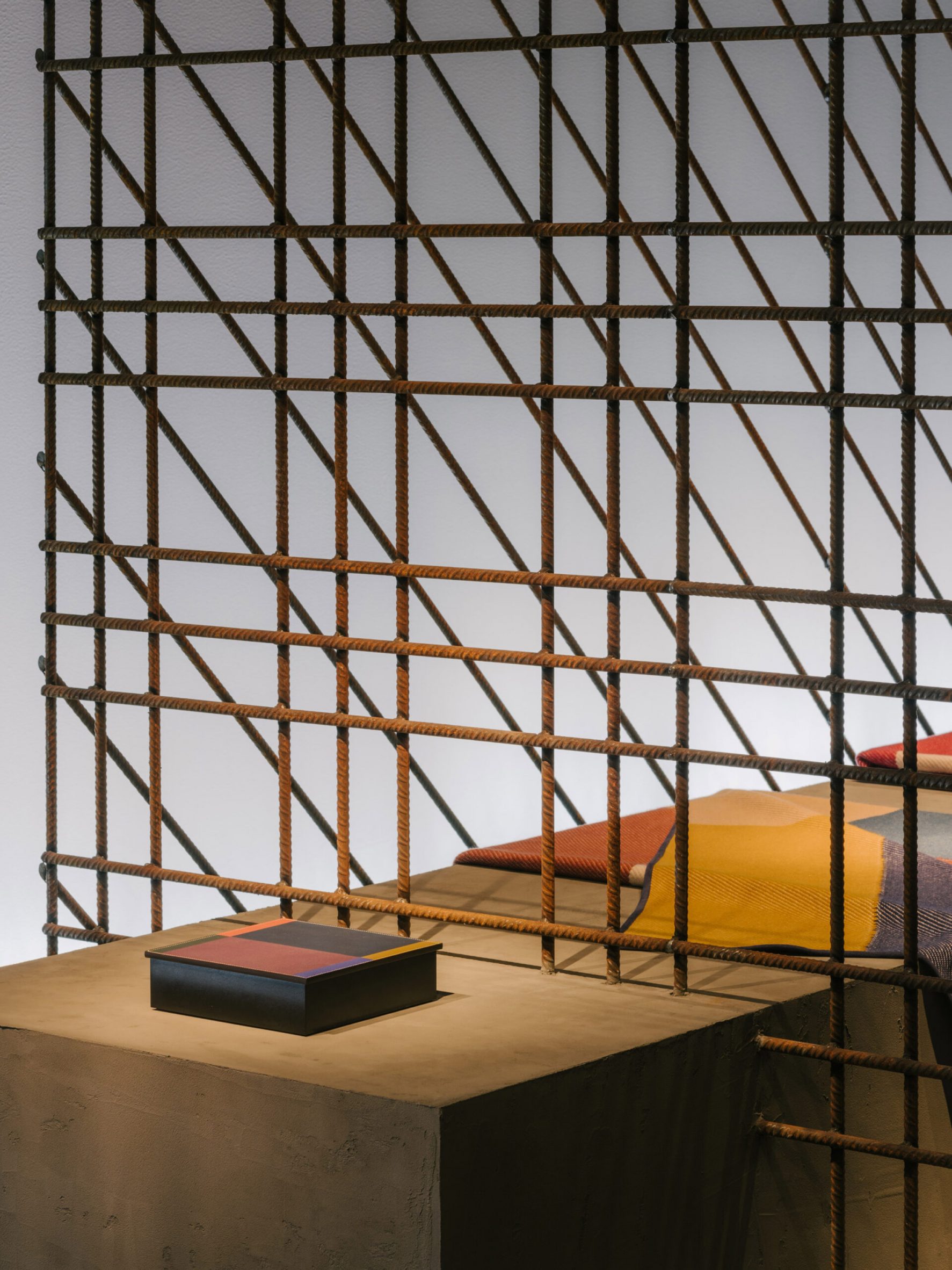 interview: Hermès encloses new home collections in transparent iron rod  installation in milan