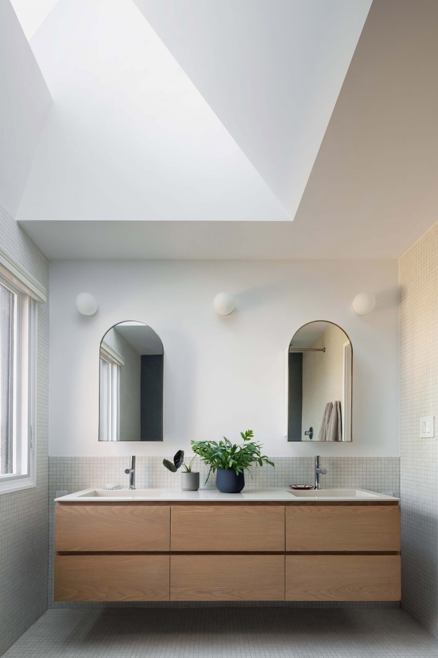Bathroom vanity with an angled skylight above