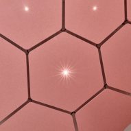 Pink hexagonal ceiling tiles with LED lights in centre