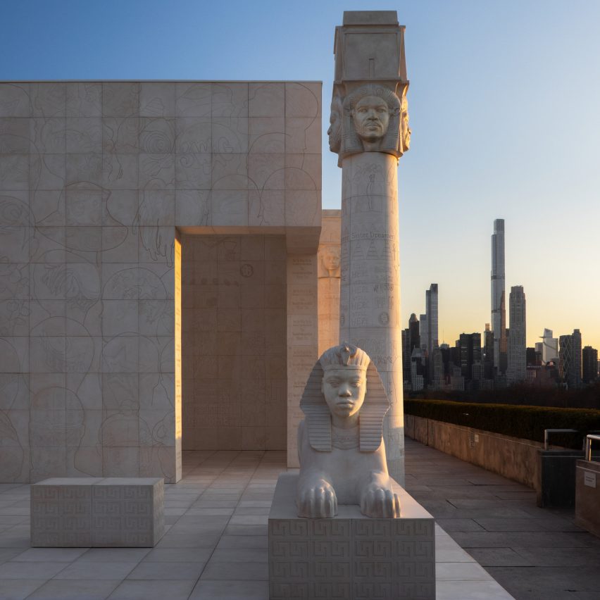 Sunset with Sphinx and pillar and New York skyline behind