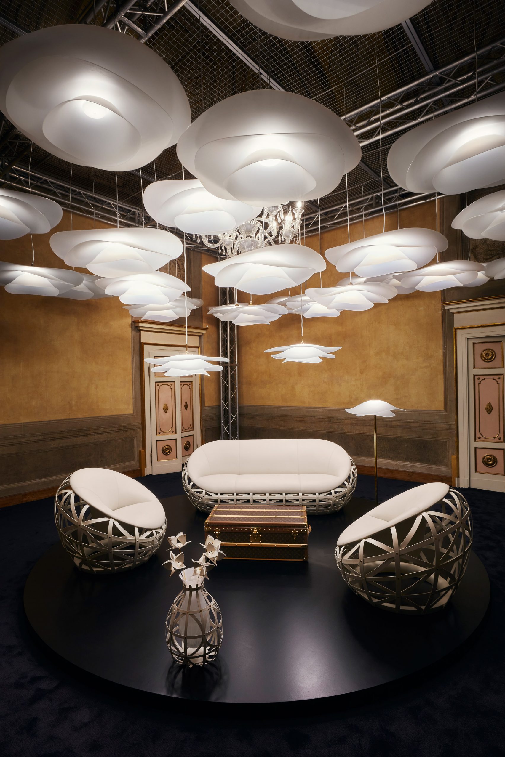Undulating lamps by Marcel Wanders suspended above seating