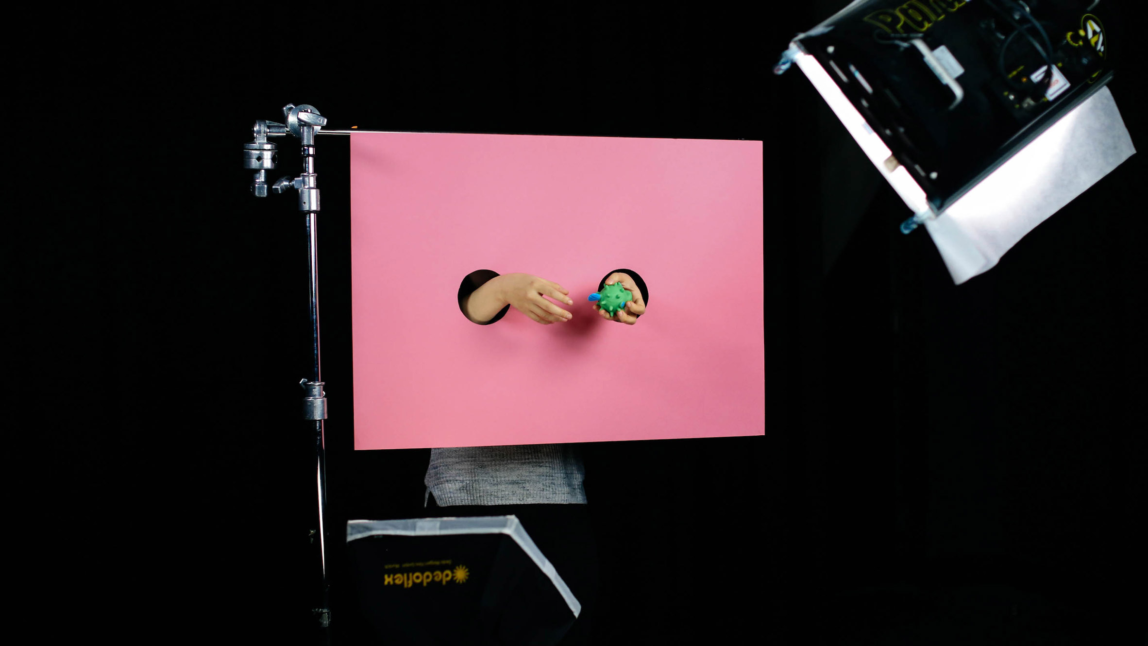 a filming set with a pink background