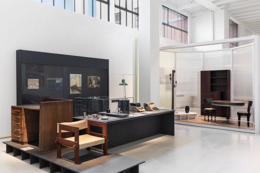 Photo of the Museo del Design Italiano exhibition showing wooden furniture in the foreground, objects in display cases in the middle ground and an interior installation in the background