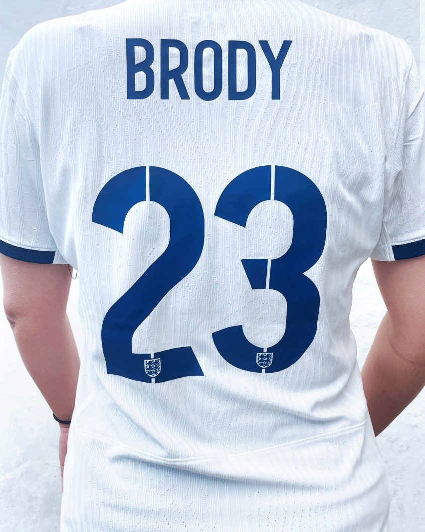 Stencil-like slits on numbers on the back of an England football shirt
