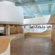 Interior of the Bronx Children's Museum with wood flooring and curved wooden elevated walkways