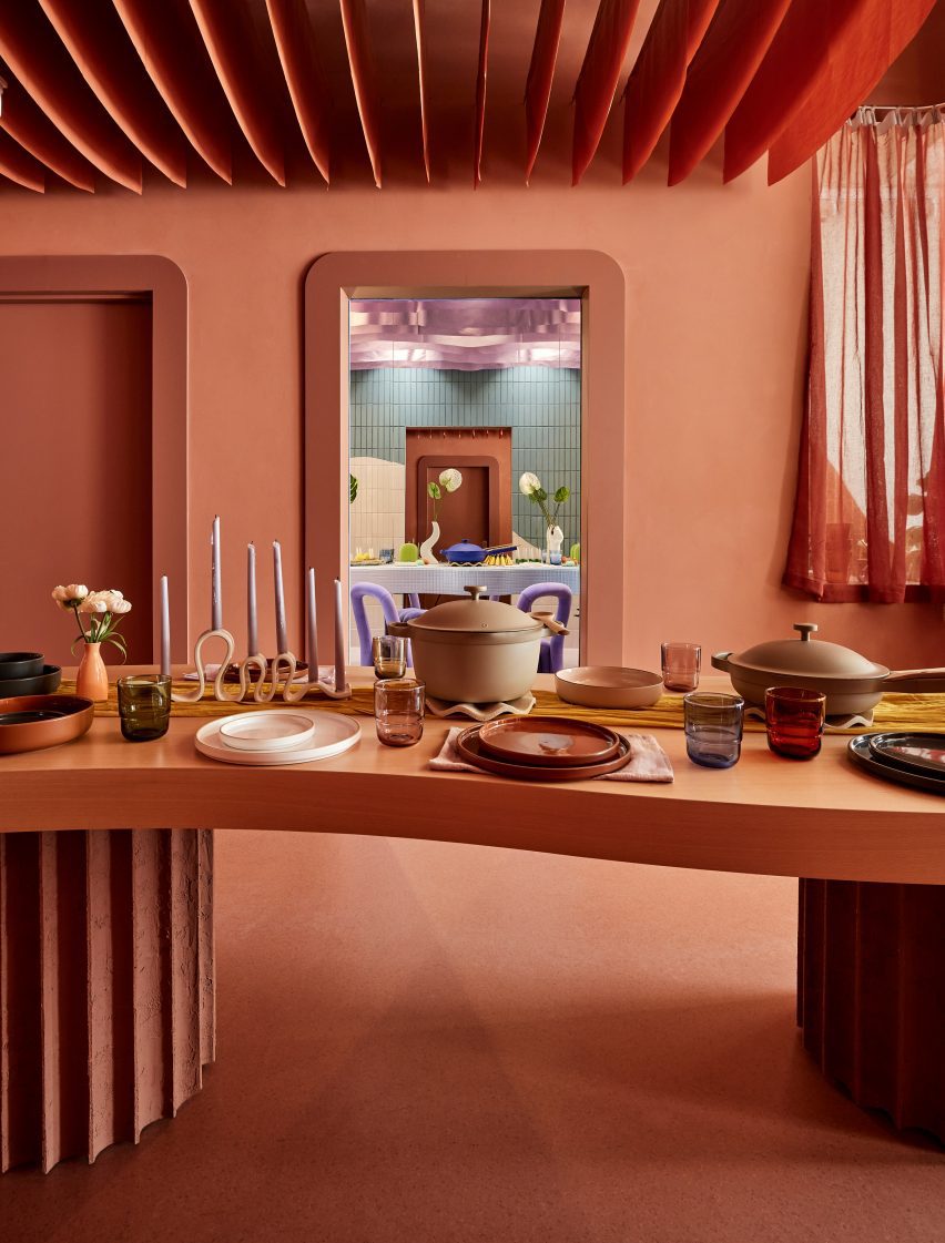 An entirely terracotta-coloured space with a dining table laid with Our Place products