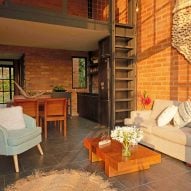 Open-plan living space with brick walls and mezzanine level