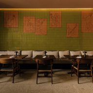 Green and orange tiled mural in interior by Space Copenhagen