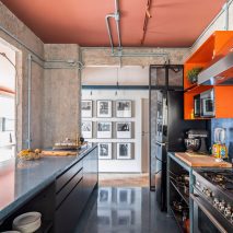 Kitchen at the RF Apartment with concrete walls and peach ceiling