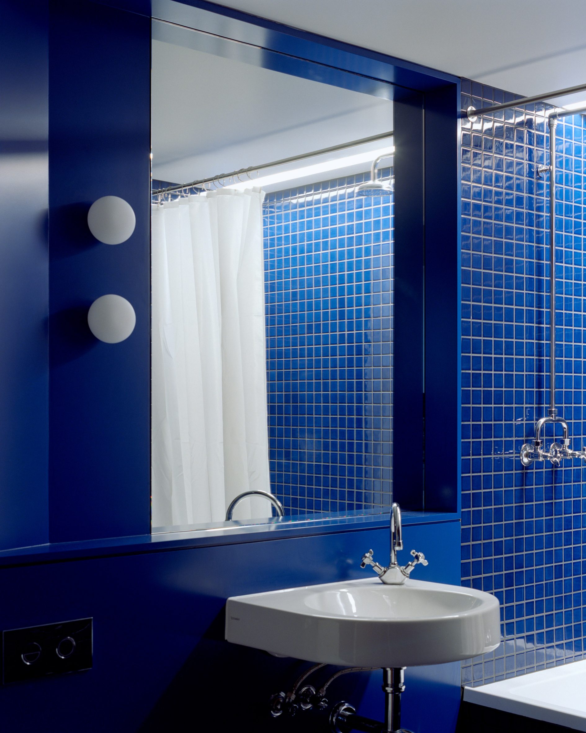 Bright blue tiles in bathroom of Kerr apartment in Melbourne