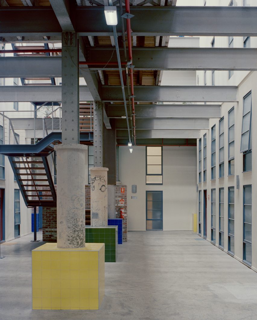 Colourful tiles within industrial atrium of apartment block in a converted factory in Melbourne