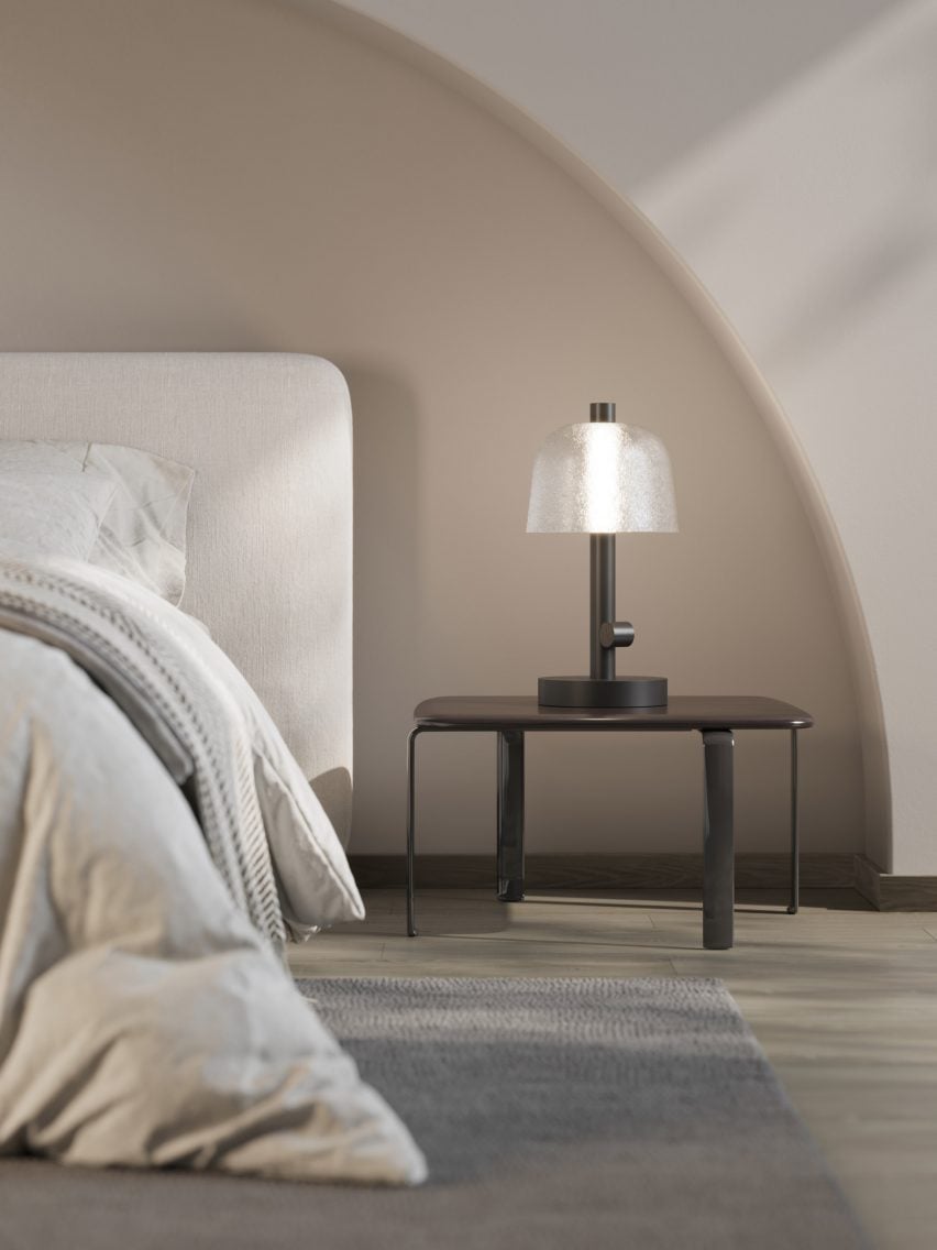 Photo of the Symbioosa table lamp on a bedside table in a neutral-coloured bedroom