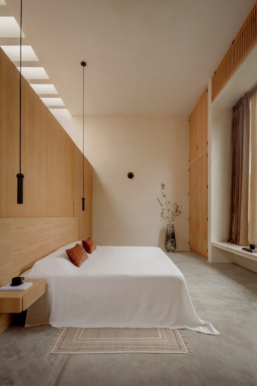 Bedroom at Villa Cava with light timber accents and smooth concrete flooring