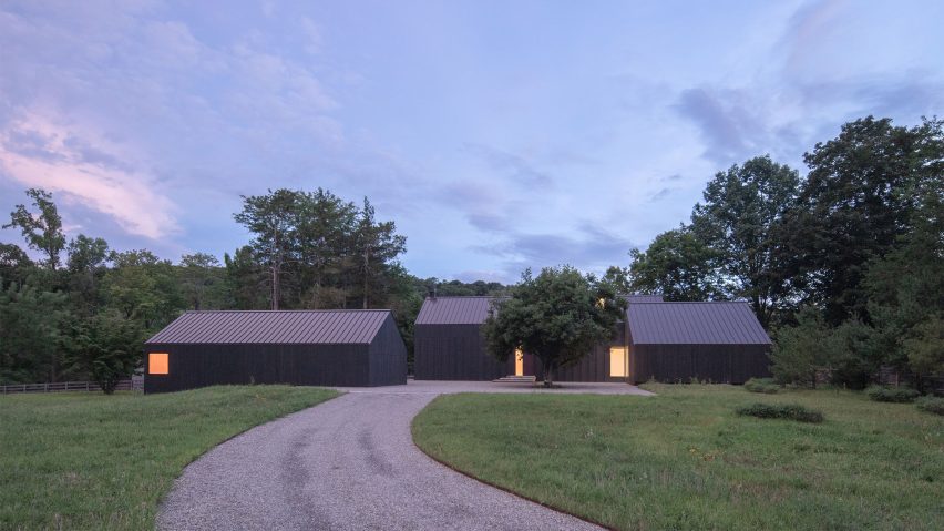 Black timber barn-style buildings by Worrell Yeung