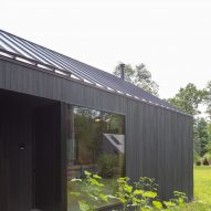 Black timber-clad home in a garden