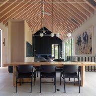 Open-plan living and dining space with an exposed timber pitched roof