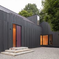 Entrance to a black timber barn-style home