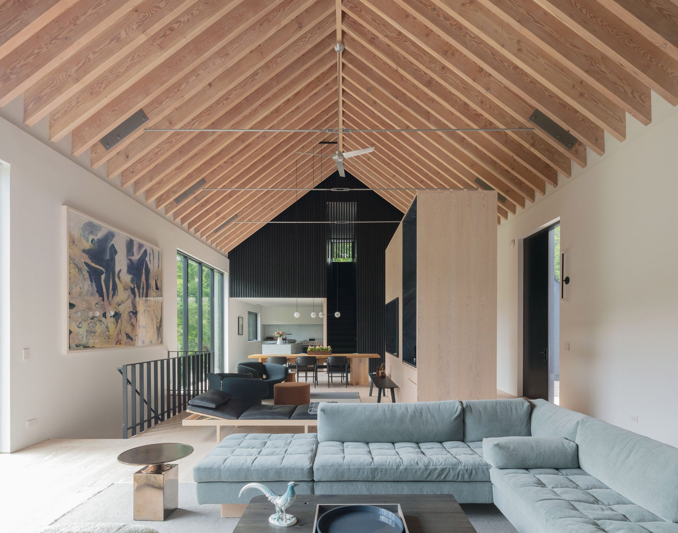 Open-plan living space with exposed pitched timber roof and rafters