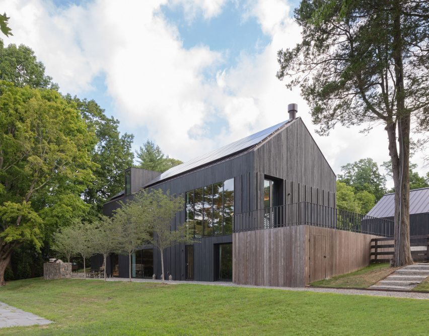 Black timber barn-style buildings by Worrell Yeung